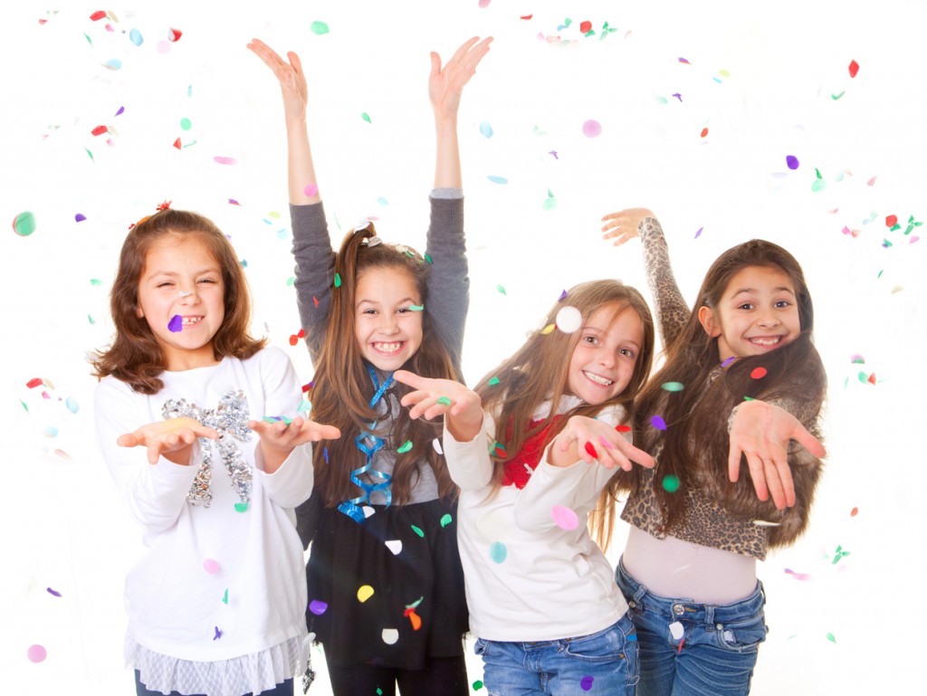 Happy young girls at a party with confetti.